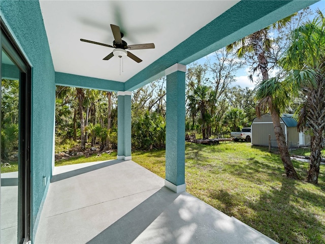 view of patio featuring ceiling fan and a storage shed