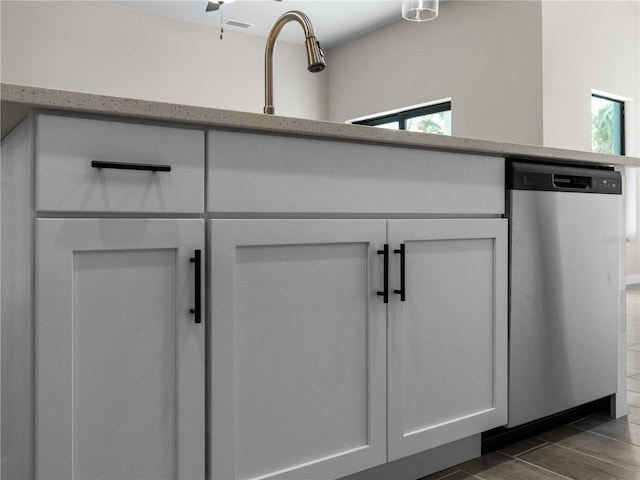 room details with white cabinets, dark hardwood / wood-style floors, sink, and dishwasher