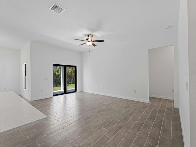 empty room with ceiling fan and dark hardwood / wood-style flooring