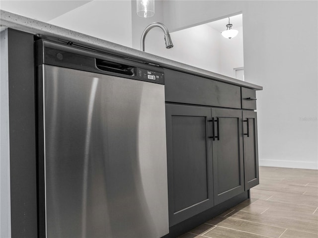 kitchen with gray cabinets, wood-type flooring, decorative light fixtures, and dishwasher