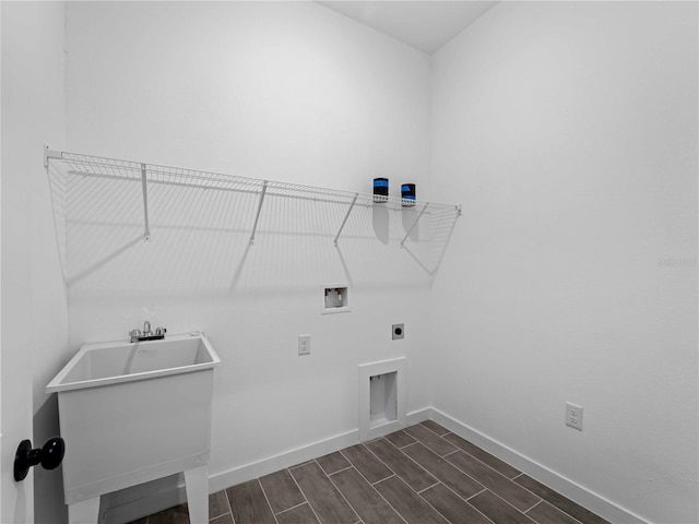 laundry area featuring hookup for an electric dryer, dark hardwood / wood-style flooring, washer hookup, and sink