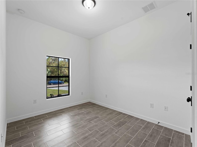 empty room with hardwood / wood-style floors