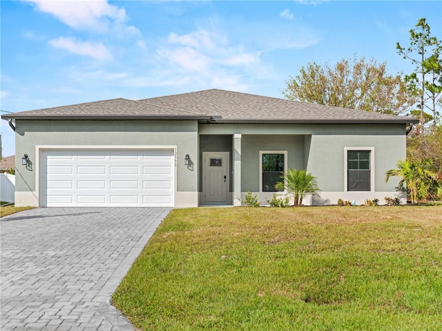 view of front of house with a garage and a front lawn