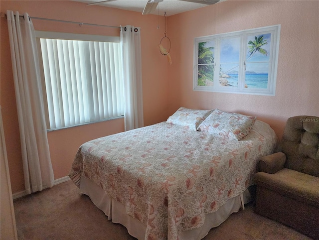 bedroom with ceiling fan and carpet flooring