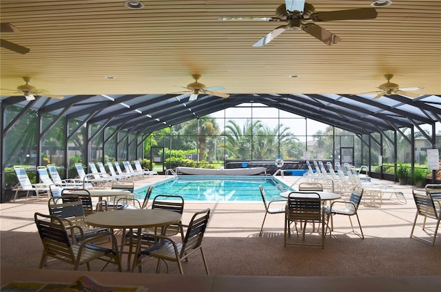 view of swimming pool with a patio area, ceiling fan, and a lanai