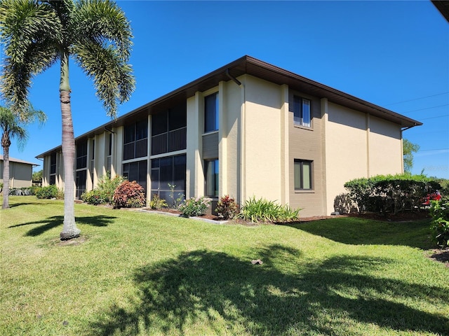 view of side of property with a lawn