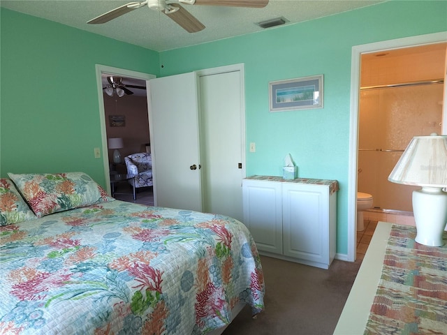 tiled bedroom with ceiling fan and ensuite bath