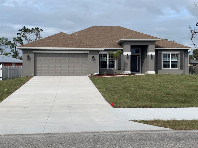 view of front facade featuring a garage and a front yard