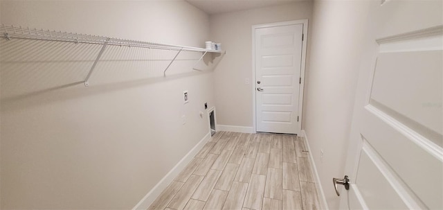 laundry room with electric dryer hookup and light hardwood / wood-style floors