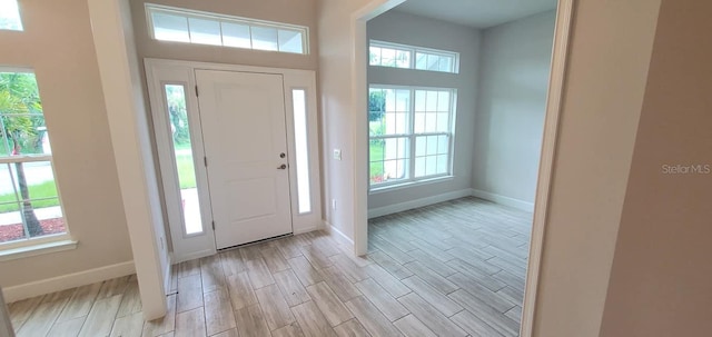 foyer entrance with light hardwood / wood-style flooring