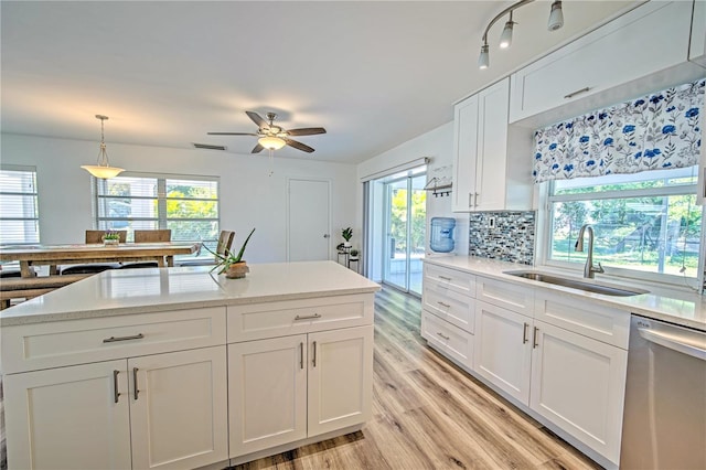 kitchen with light hardwood / wood-style flooring, sink, a healthy amount of sunlight, and dishwasher