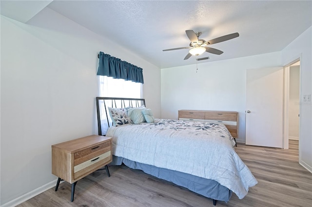 bedroom featuring ceiling fan and hardwood / wood-style flooring