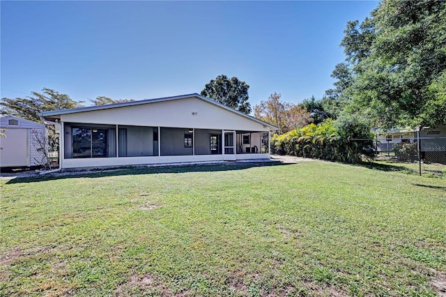 rear view of house with a lawn