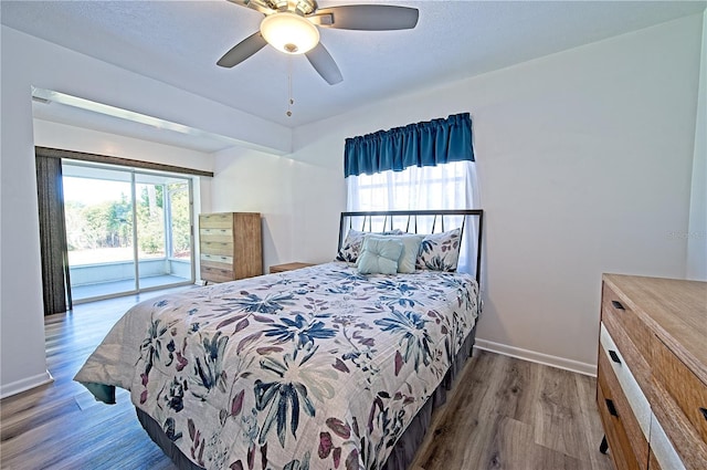 bedroom featuring ceiling fan, hardwood / wood-style floors, and access to outside