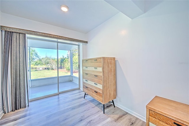 bedroom featuring lofted ceiling, hardwood / wood-style flooring, and access to outside