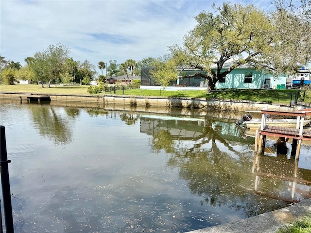 dock area with a water view and a lanai