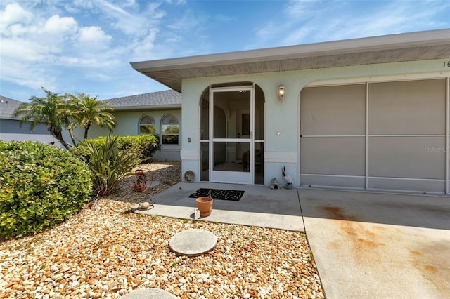 view of exterior entry featuring a garage