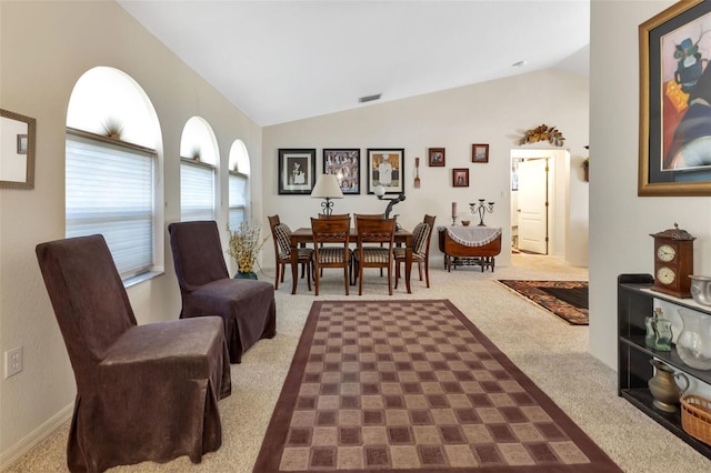 living area featuring carpet floors and lofted ceiling