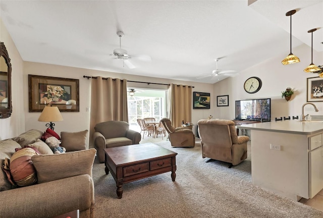 carpeted living room with lofted ceiling and sink