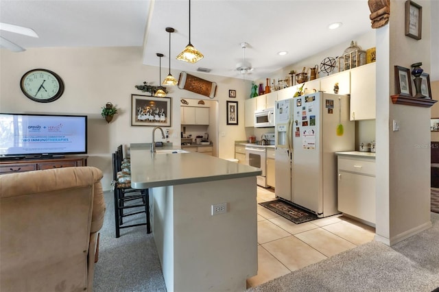 kitchen featuring white appliances, light colored carpet, ceiling fan, sink, and decorative light fixtures