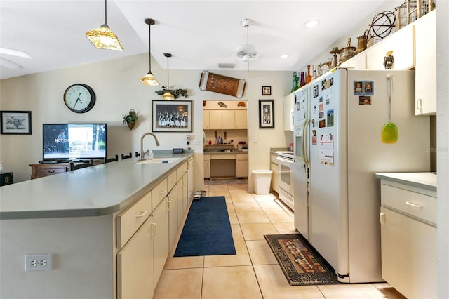 kitchen featuring a large island, sink, ceiling fan, lofted ceiling, and white appliances