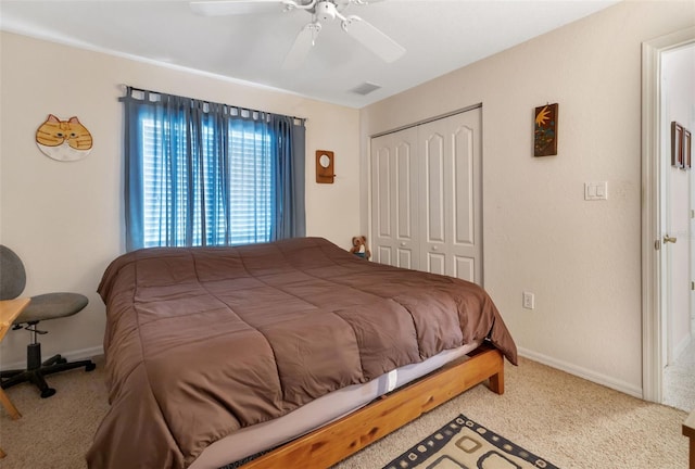 carpeted bedroom featuring ceiling fan and a closet