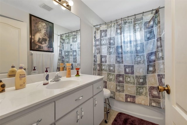 full bathroom featuring toilet, vanity, tile patterned floors, and shower / bath combo with shower curtain