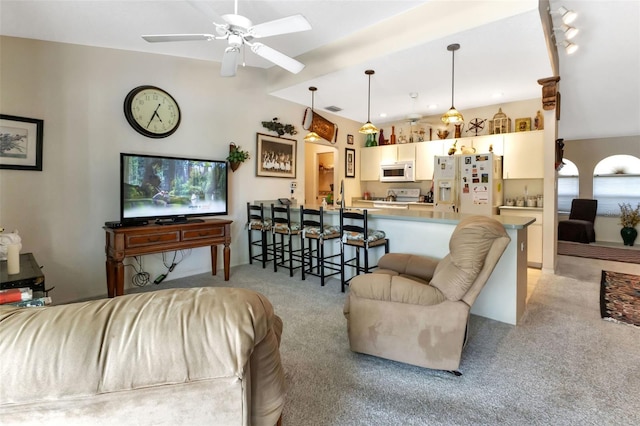 carpeted living room featuring vaulted ceiling and ceiling fan