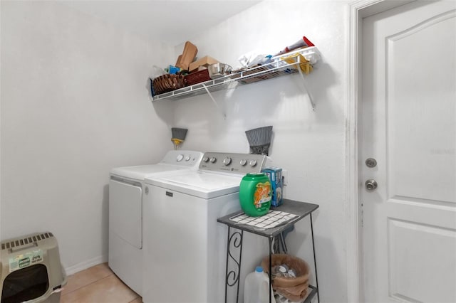 laundry area with washer and dryer and light tile patterned flooring