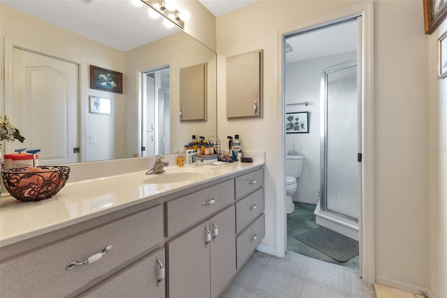 bathroom featuring vanity, a shower with shower door, and toilet