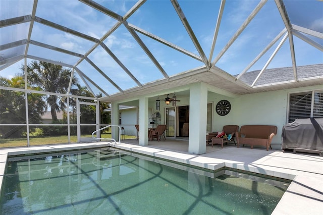 view of swimming pool with an outdoor hangout area, glass enclosure, ceiling fan, and a patio area