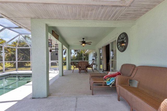 view of patio / terrace featuring glass enclosure and ceiling fan