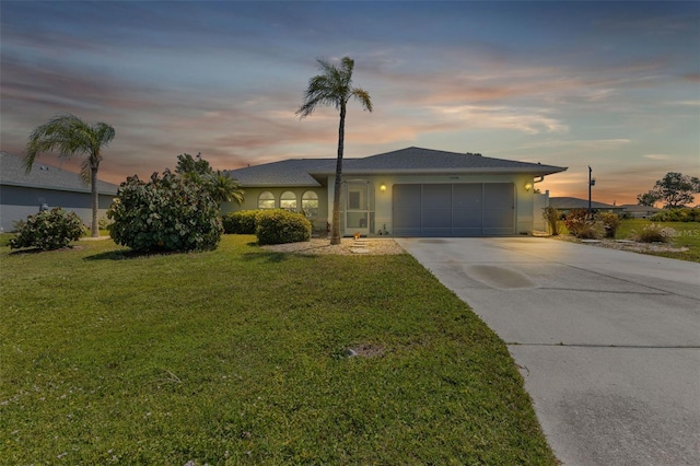 view of front of home featuring a lawn and a garage