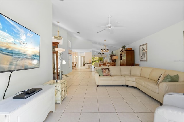 living room with lofted ceiling, light tile floors, and ceiling fan with notable chandelier