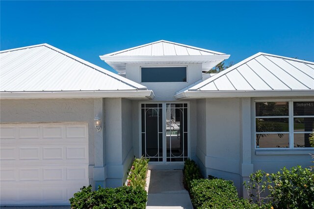 view of exterior entry featuring a garage