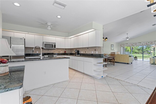 kitchen with ceiling fan, white cabinetry, tasteful backsplash, and stainless steel appliances