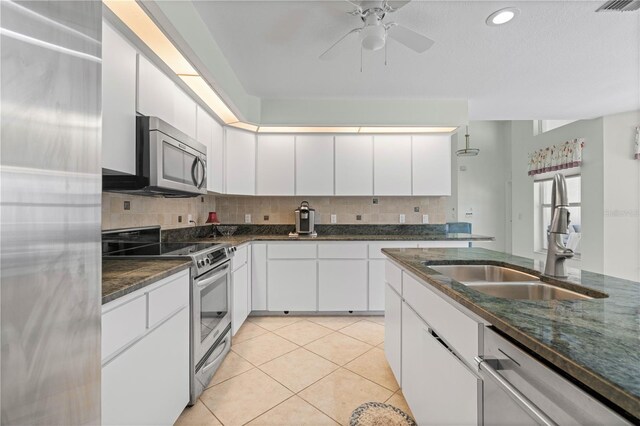 kitchen with tasteful backsplash, stainless steel appliances, and white cabinetry