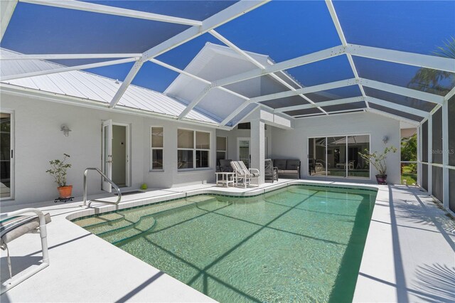 view of swimming pool featuring a lanai and a patio