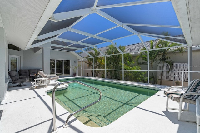 view of swimming pool featuring a lanai and a patio