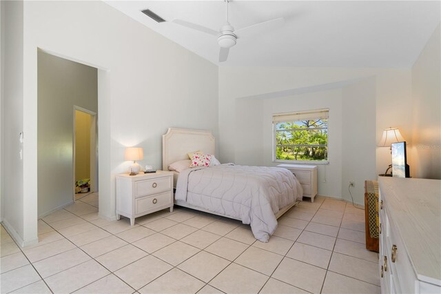 tiled bedroom with ceiling fan and vaulted ceiling