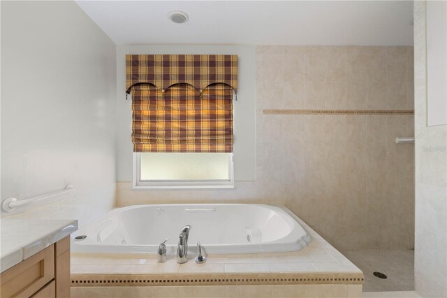 bathroom featuring shower with separate bathtub and vanity