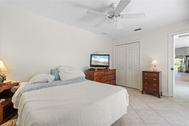 tiled bedroom with a closet and ceiling fan