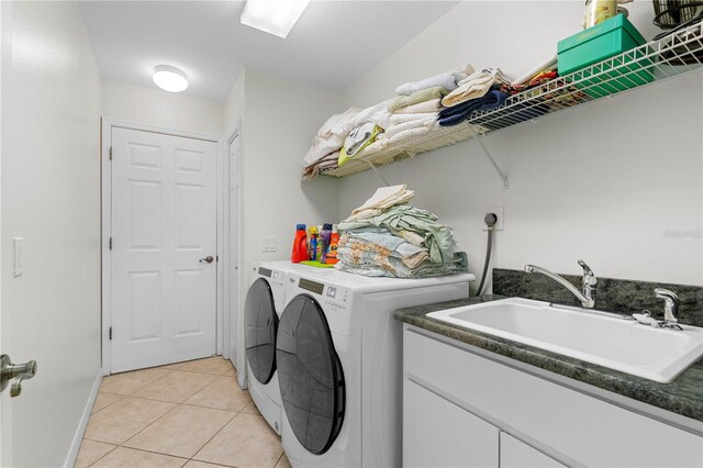 laundry room with light tile flooring, sink, washer and clothes dryer, and electric dryer hookup