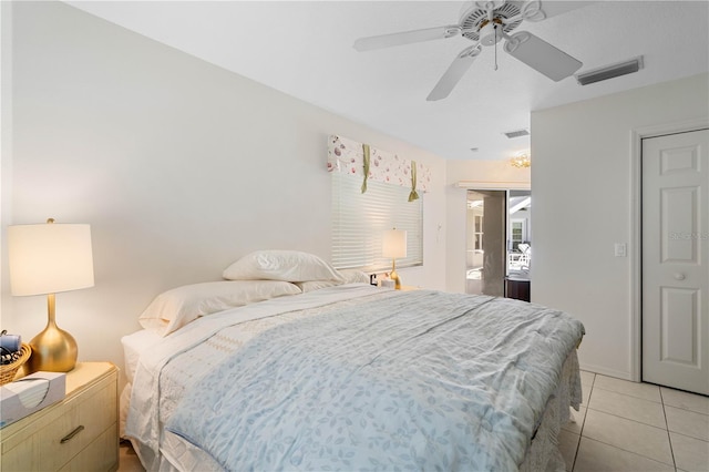 tiled bedroom with ceiling fan