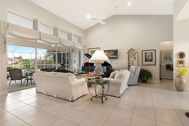 tiled living room with ceiling fan and high vaulted ceiling