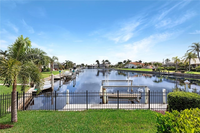 view of dock with a water view and a yard