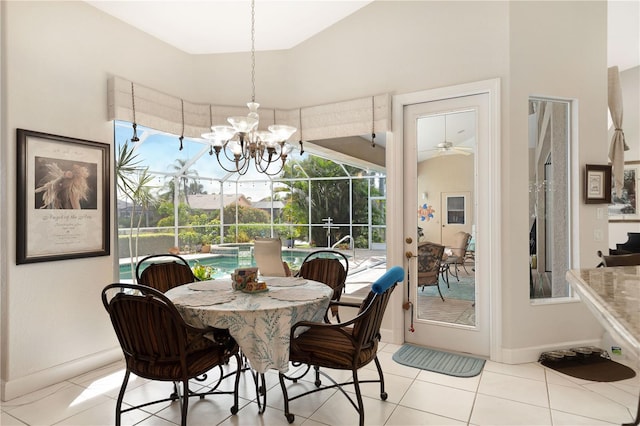 dining space with ceiling fan with notable chandelier and light tile floors