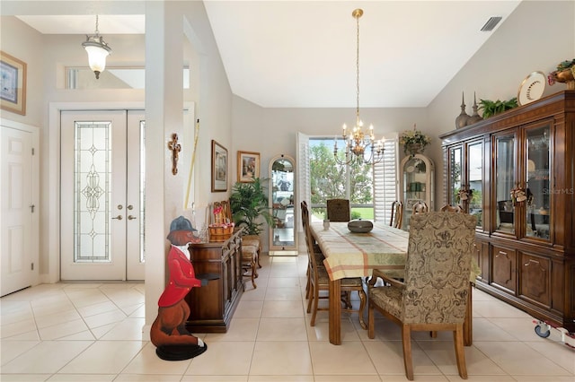 tiled dining room featuring a notable chandelier