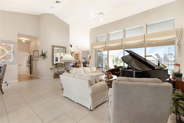 living room with light tile flooring, ceiling fan, and high vaulted ceiling