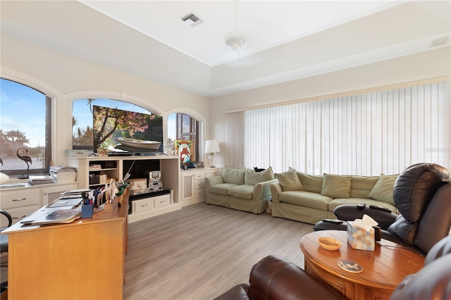 living room featuring plenty of natural light and light hardwood / wood-style floors